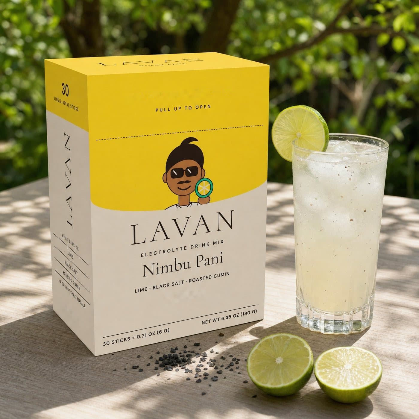 Nimbu Pani box outdoors with an iced glass and cut limes